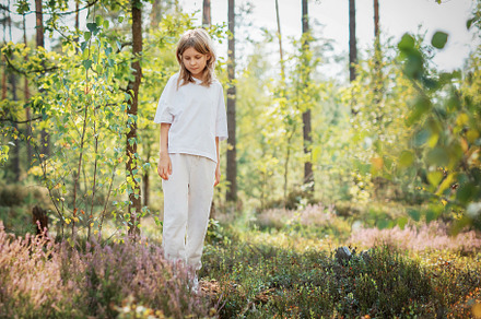 A young girl explores a serene forest in bright daylight, surrou, a Person Photo by Olena Rudo
