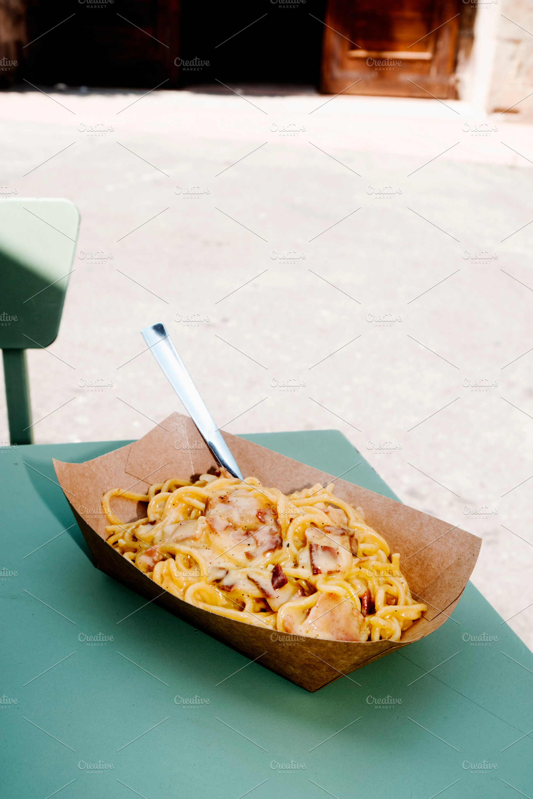spaghetti alla carbonara in a brown paper bowl, a Photo by Nito