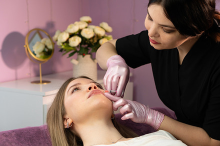 Practitioner performs chin filler