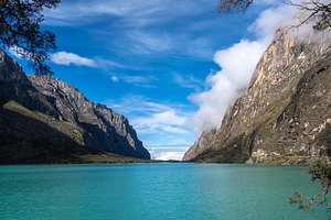 Turquoise lake surrounded by mountains on the Laguna 69 trek, Pe, a Photo by GoodGoods