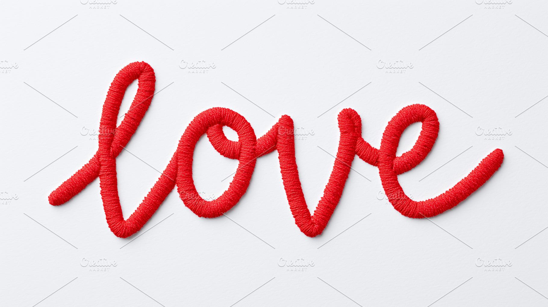 Red embroidered word “love” isolated, a Holiday Photo by MistyDay