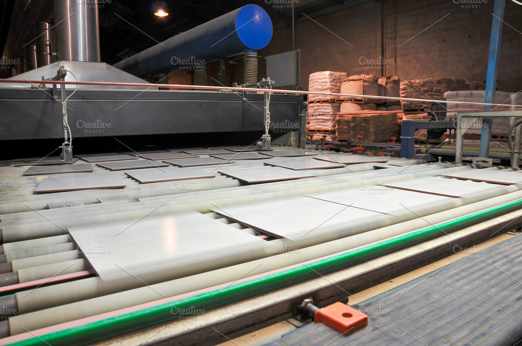 Fired ceramic tiles exiting kiln on rollers, an Industrial Photo by Davizro's Market
