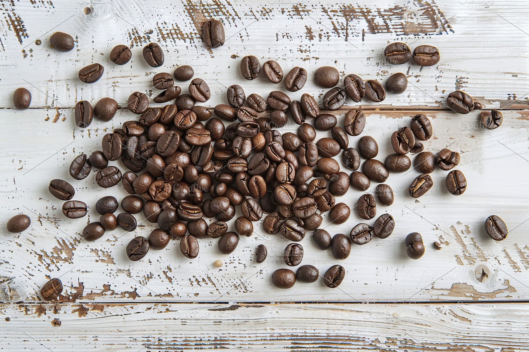 Heap of coffee beans on wooden table, a Food & Drink Photo by AlyaAnd