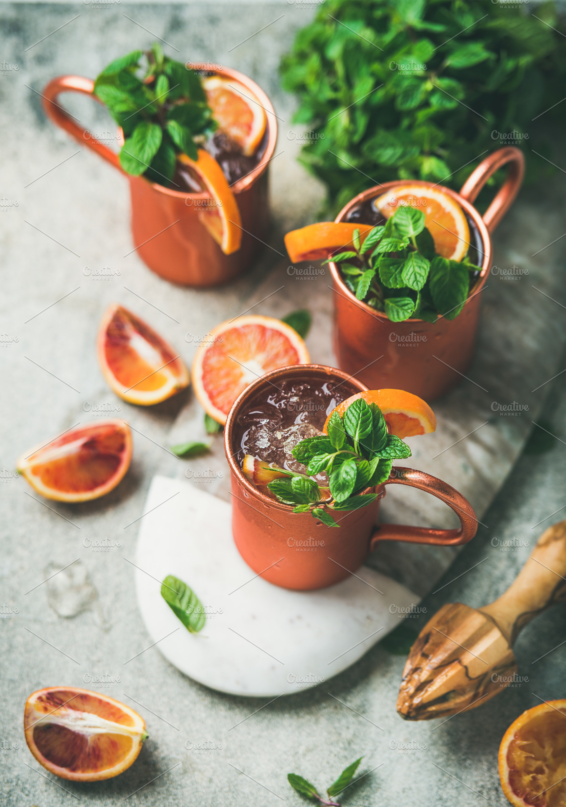 Blood orange Moscow mule alcohol cocktails over concrete background, a Food & Drink Photo by Foxys
