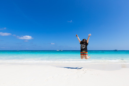 Woman jumping on the beach stock photo containing woman and beach, a Person Photo by a454