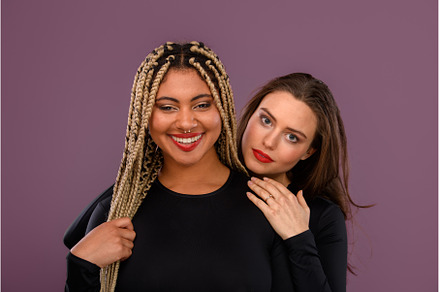 Two happy multiracial friends, a Person Photo by HalfPoint