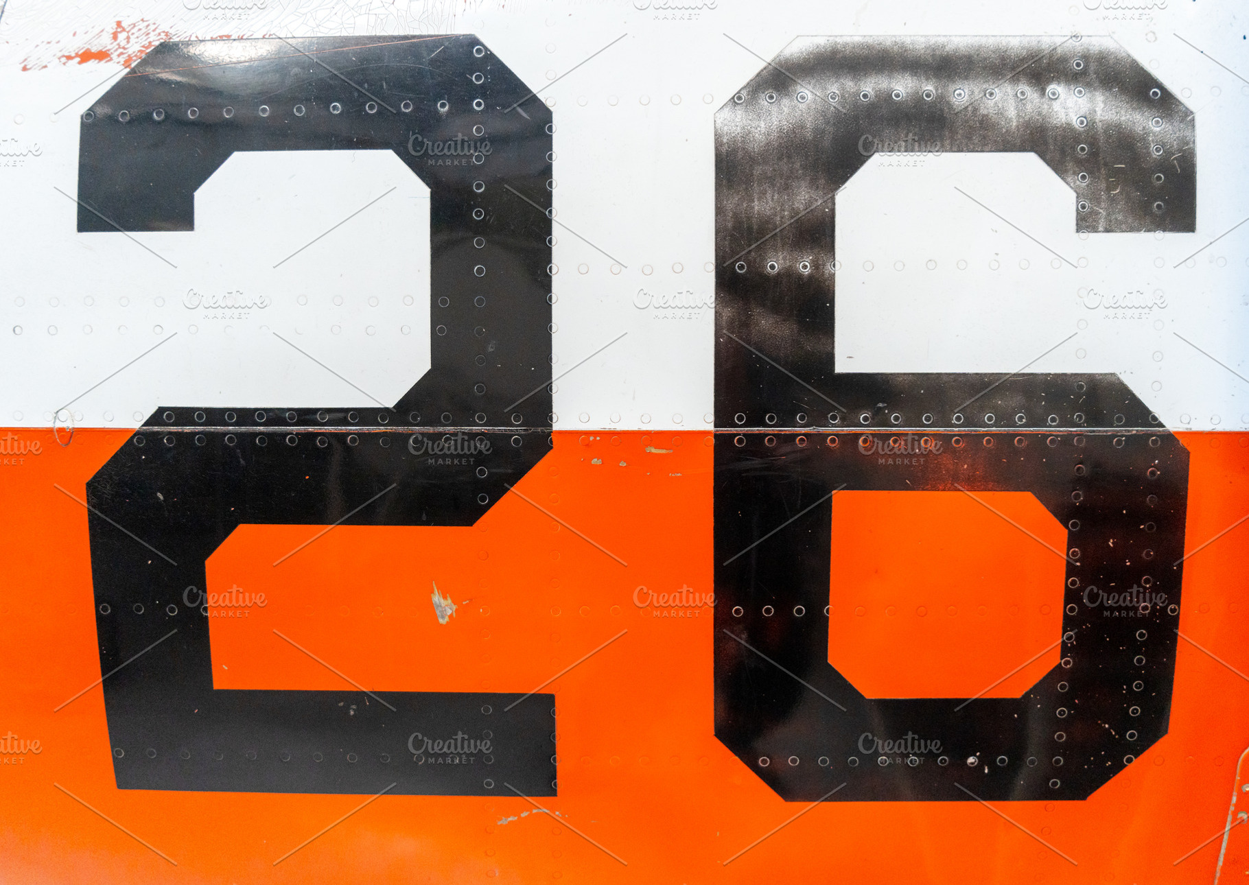 Black number -26- on an old aircraft fuselage with riveted panel, a Transportation Photo by GoodGoods