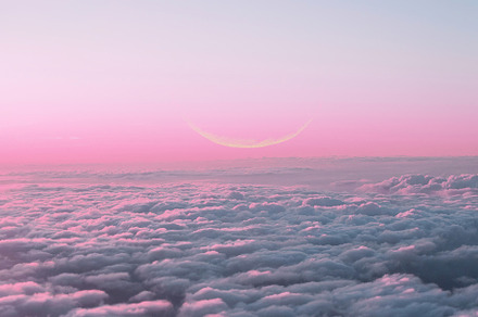 Pink sunset sky with new moon