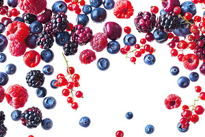 Different ripe berries flying in the air on white background, a Food & Drink Photo by AlyaAnd