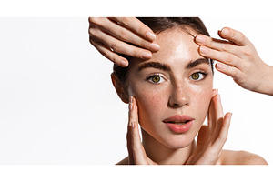 Hands massaging woman face. Girl