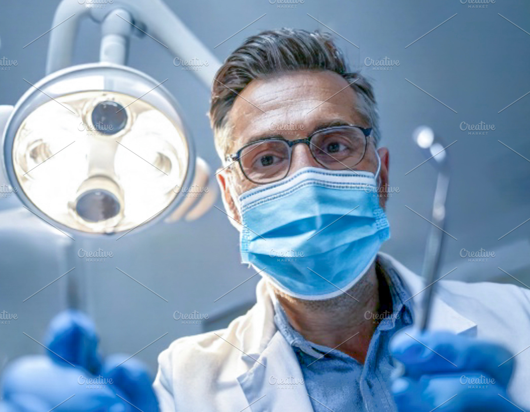 Dentist preparing under surgical light, a Health & Medical Photo by DanFLCreativo