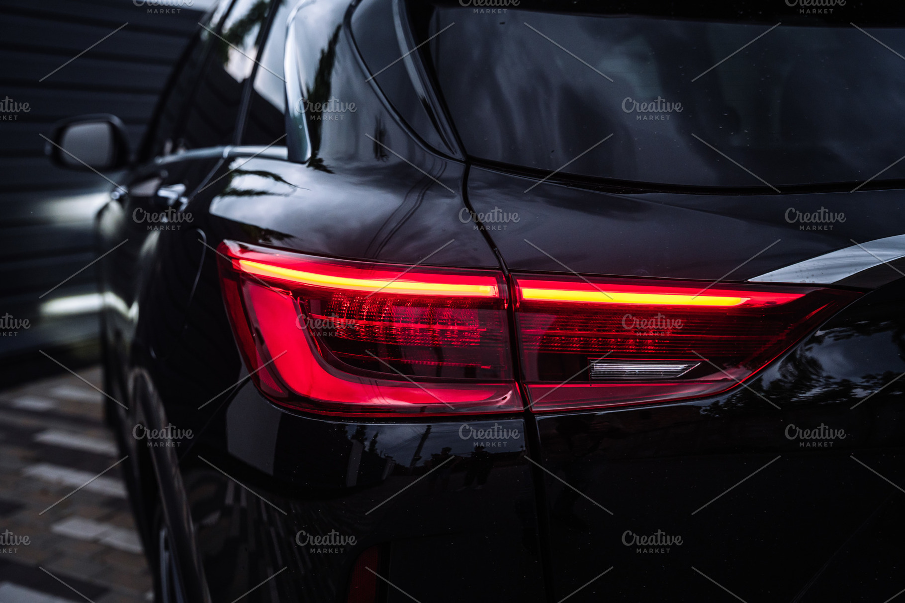 Modern Black Car Rear Taillight Close Up at Night, a Transportation Photo by Red Hot Chili Pepper Shop