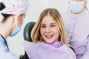 Young woman smiling during dental checkup with her dentist, a Health & Medical Photo by Antonio Gravante Market