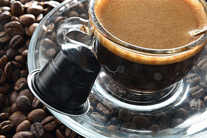 Detail of glass cup of espresso on coffee beans, a Food & Drink Photo by Davizro's Market