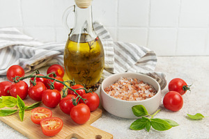 Fresh cherry tomatoes basil olive oil cooking ingredients, a Food & Drink Photo by Olena Rudo