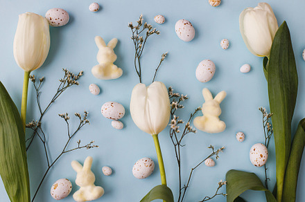 Stylish easter eggs, tulips and bunnies composition flat lay on, a Holiday Photo by Sonjachni