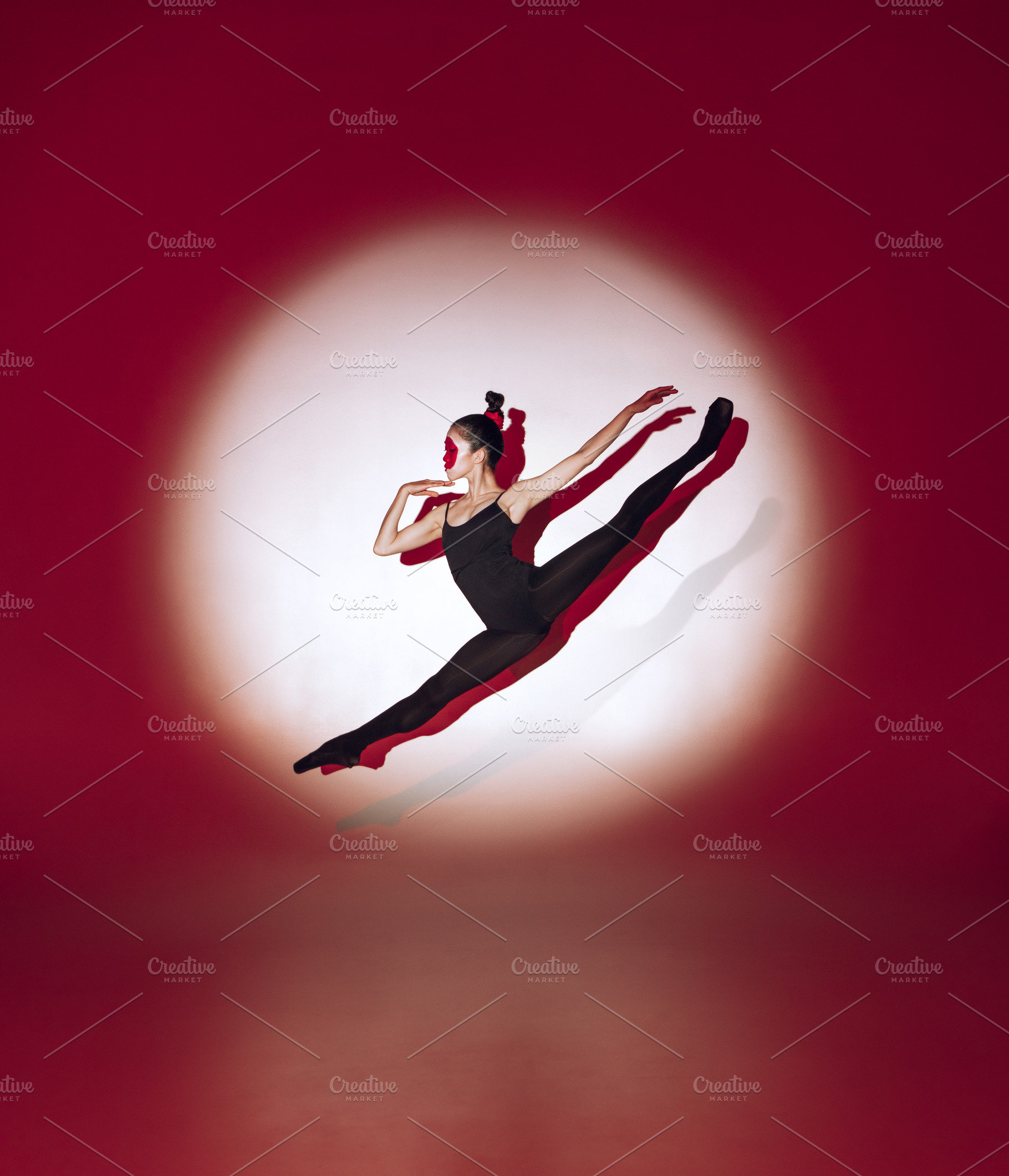 Ballet dancer dancing over red studio background. Modern design ...