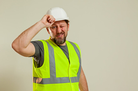 worker in a vest and white helmet, a Person Photo by Photostock