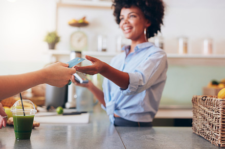 Female employee taking payment, a Business Photo by Jacob Lund