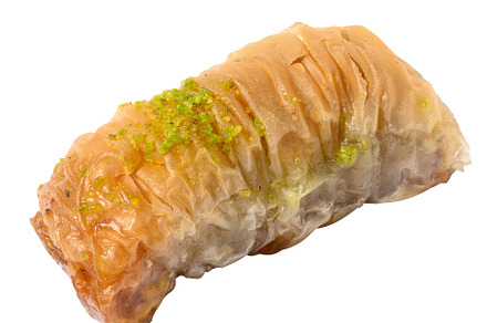 A piece of baked baklava in honey on a white isolated background, a Food & Drink Photo by ndanko