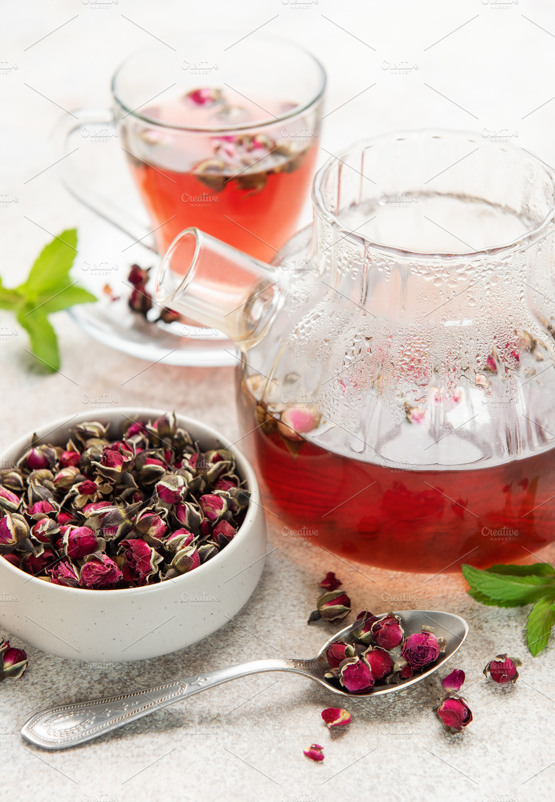 Dried rose buds brewing herbal tea infusion, a Food & Drink Photo by Olena Rudo