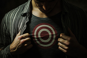Man with a target symbol on his chest, a Person Photo by AlyaAnd