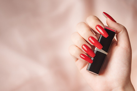 The hand of a young girl with a bright red manicure on her nails, a Beauty & Fashion Photo by Olena Rudo