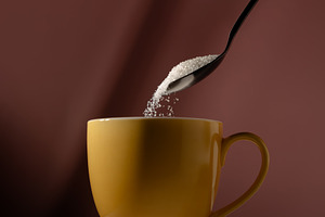 Spoon pouring sugar into a cup of drink. Concept of unhealthy di, a Photo by salmon.black
