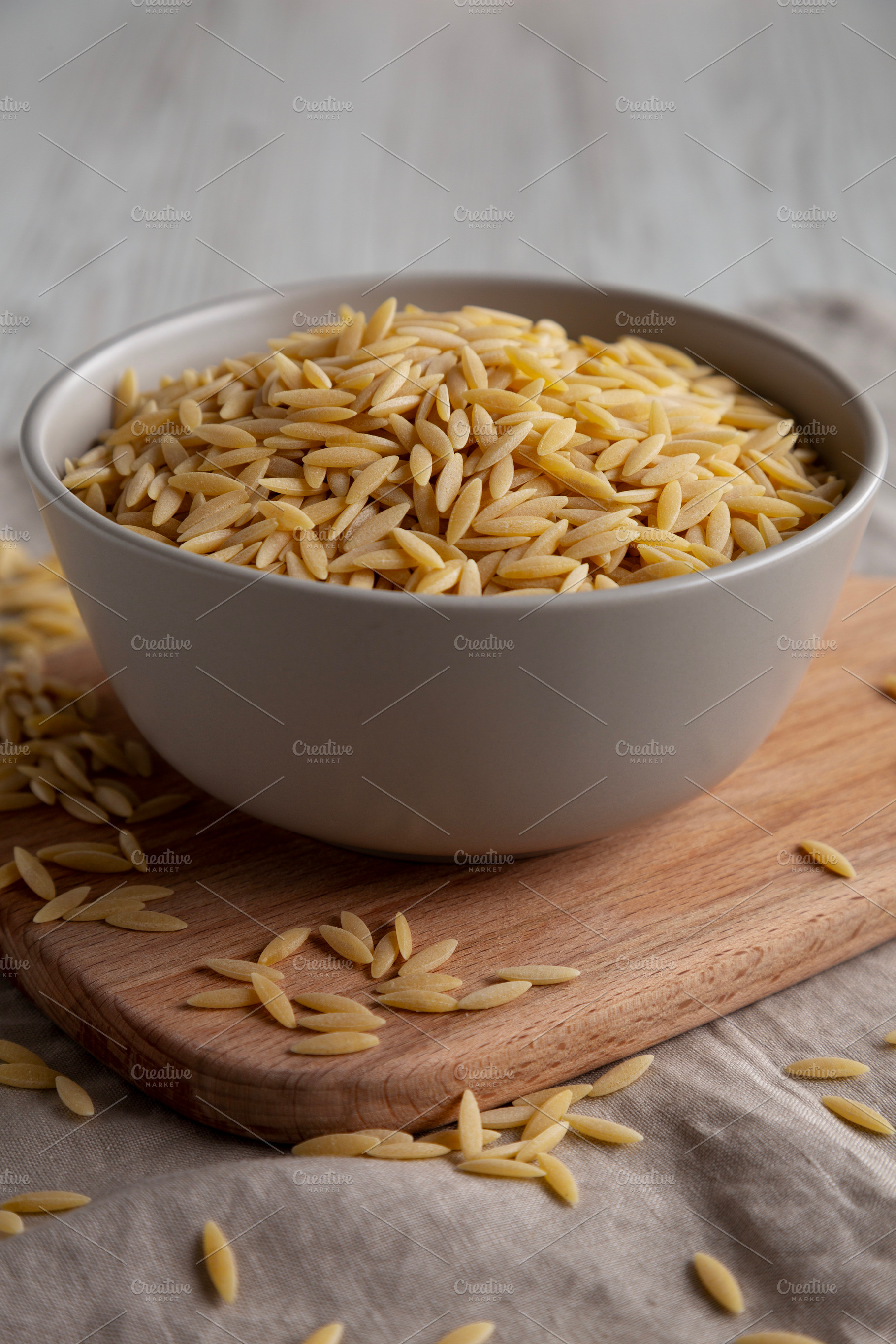 Organic Dried Orzo Pasta in a Bowl, side view. Close-up., a Food & Drink Photo by LiudmylaChuhunova