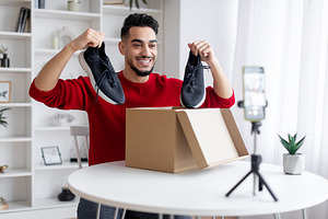 Unboxing Video. Arab Male Blogger Recording Content For His Blog At Home, a Photo by Prostock-Studio