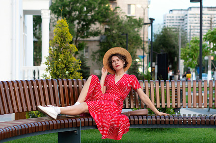 Woman lounges playfully on bench