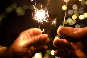 Happy New Year! Burning sparklers in hands on background of chri, a Holiday Photo by Sonjachni