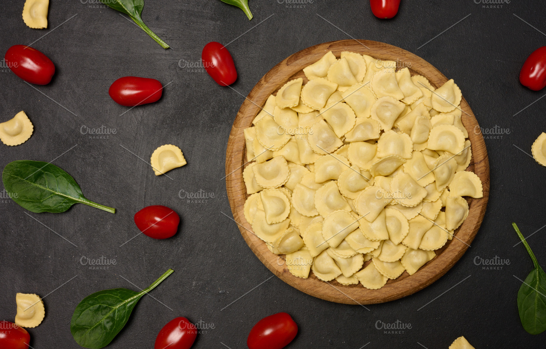 Uncooked tortellini pasta with fresh cherry tomatoes and spinach, a Food & Drink Photo by ndanko