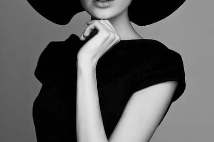 Woman retro fashion portrait containing black, white, and hat