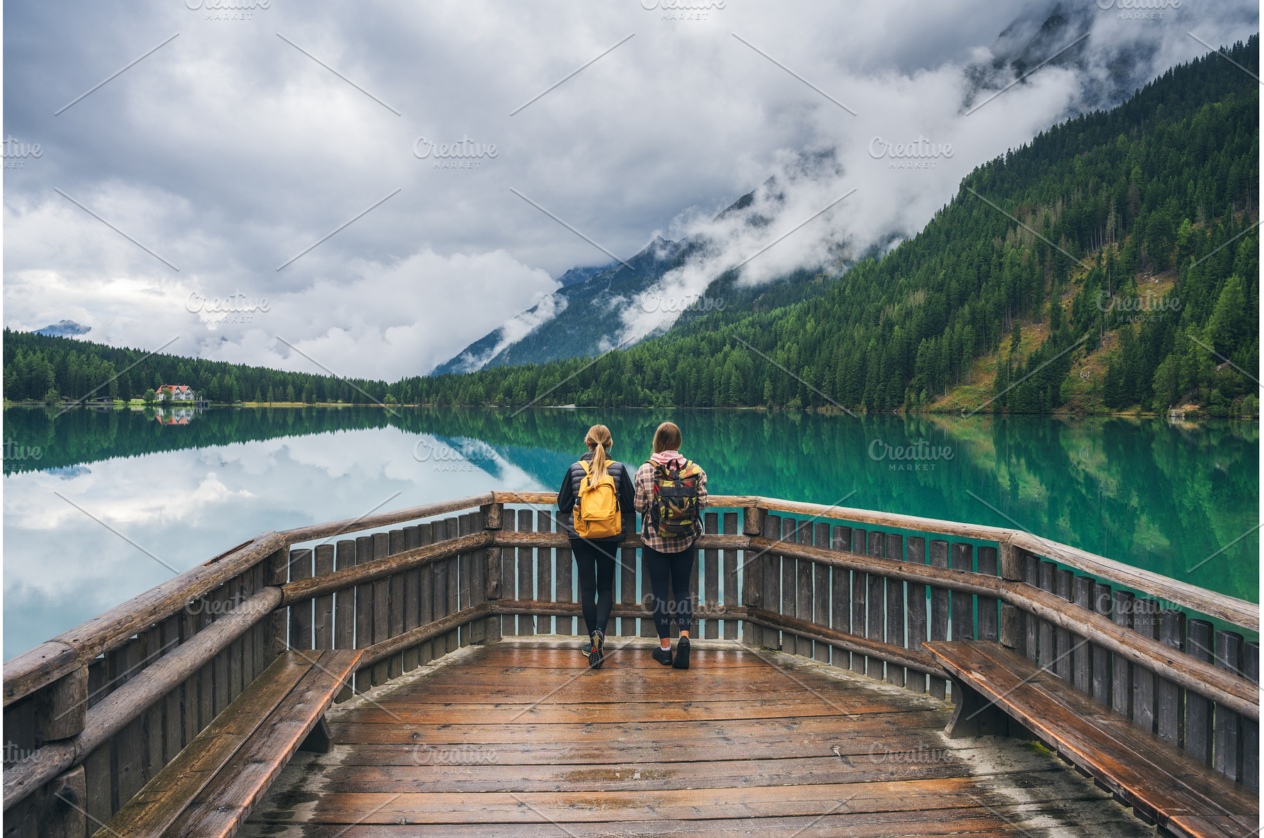 Two women with backpacks standing on, a Person Photo by den-belitsky