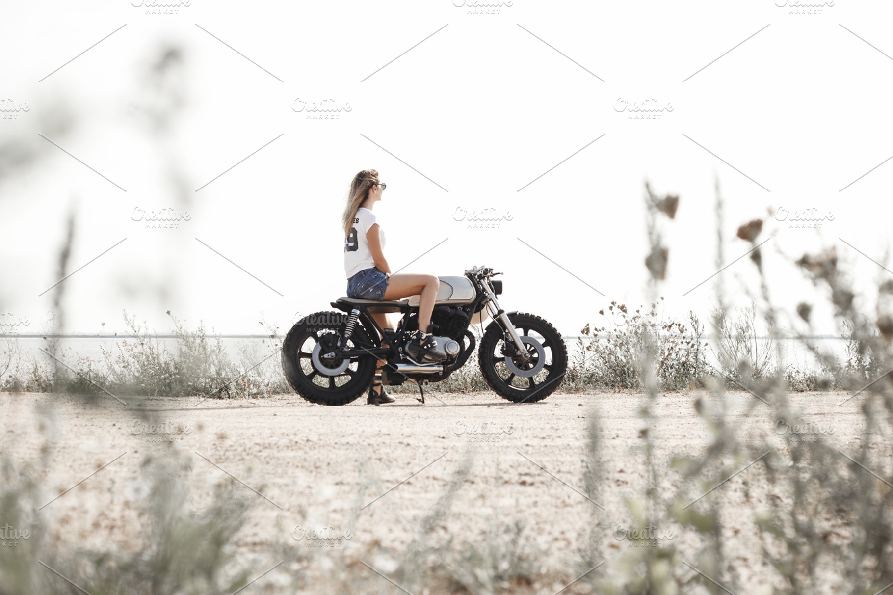 Woman and motorcycle on road stock photo containing background and retro, a Transportation Photo by Aliaksei Kaponia