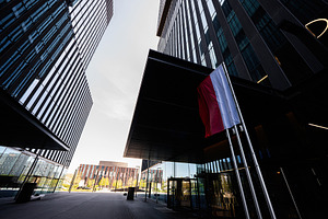 Modern business architecture with Polish flag at corporate entrance in Katowice, a Photo by AS photostudio