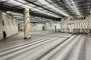 Empty modern airport terminal interior with luggage carts and directional signa, a Photo by AS photostudio
