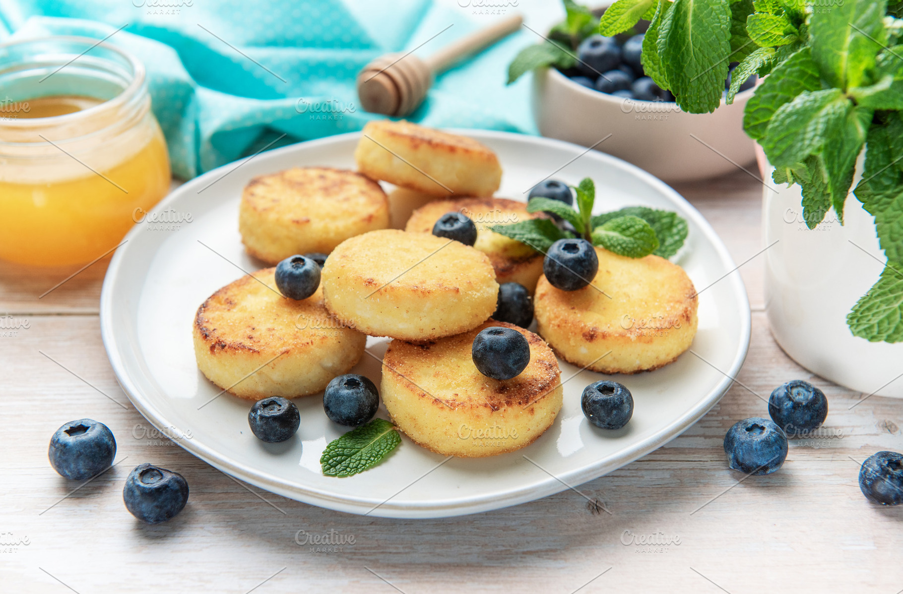 Syrniki curd pancakes with blueberries and honey for breakfast, a Food & Drink Photo by Olena Rudo