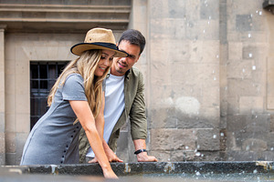 Romantic couple laughing by historic fountain, a Person Photo by etorres69