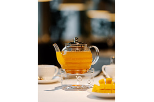 Mango herbal tea in teapot with, a Food & Drink Photo by Fascinadora