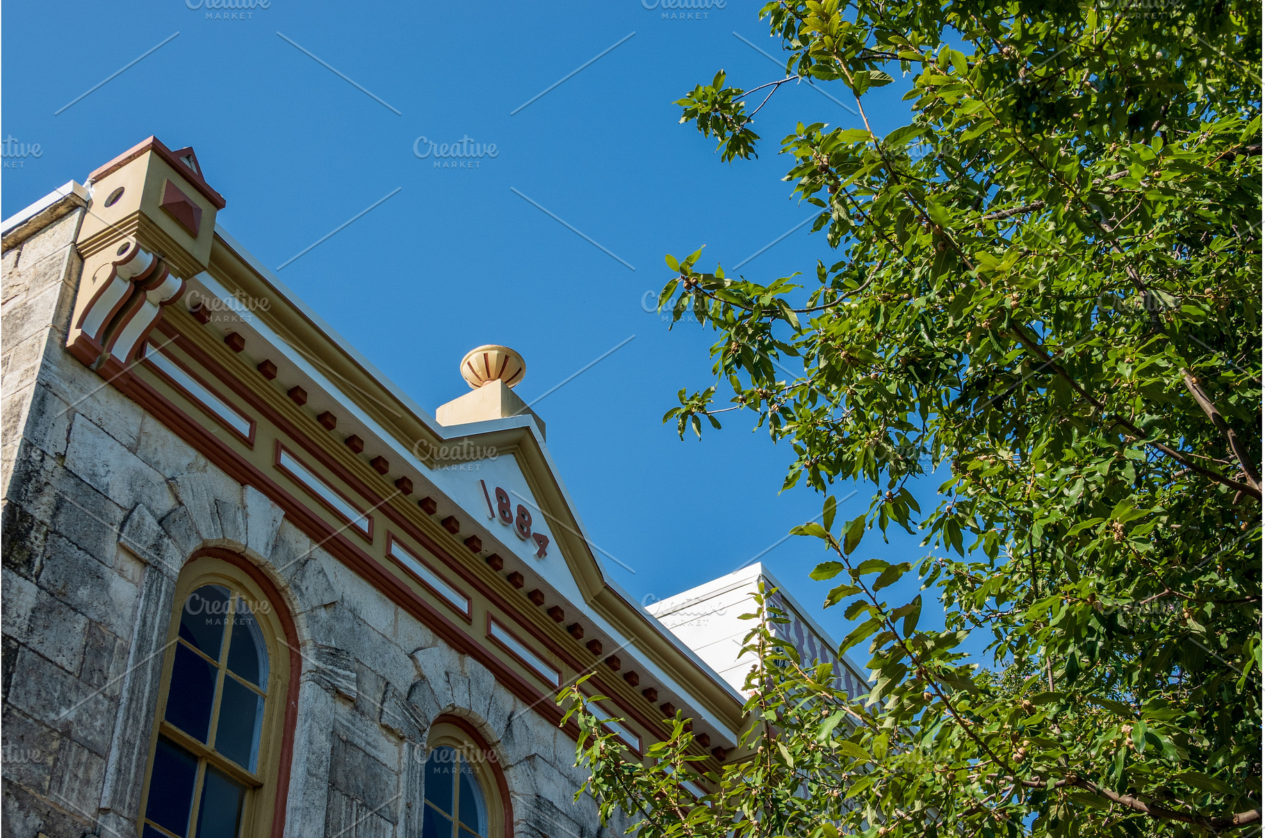 Ornate roofline showing 1884 on, an Architecture Photo by Backyard Stock