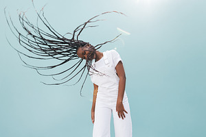 Young female waving her long braids, a Person Photo by Artem Varnitsin