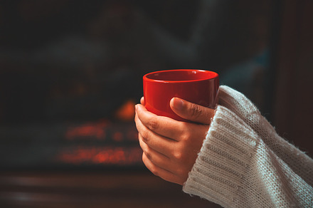Girl in sweater holding a cup stock photo containing cup and up