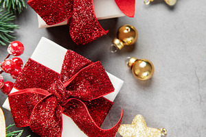 Christmas presents with festive decorations on gray background, a Holiday Photo by Olena Rudo