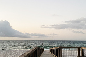 Serene Pensacola beach boardwalk leads to ocean at sunset in Florida USA, a Nature Photo by AS photostudio