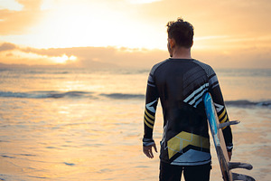 Surfer Watching Sunset at the Beach, a Photo by bastera