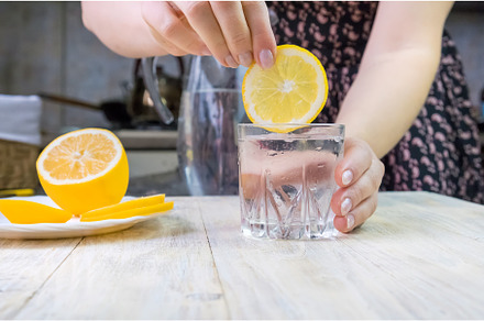 The girl pours water with lemon, a Person Photo by yanadjana