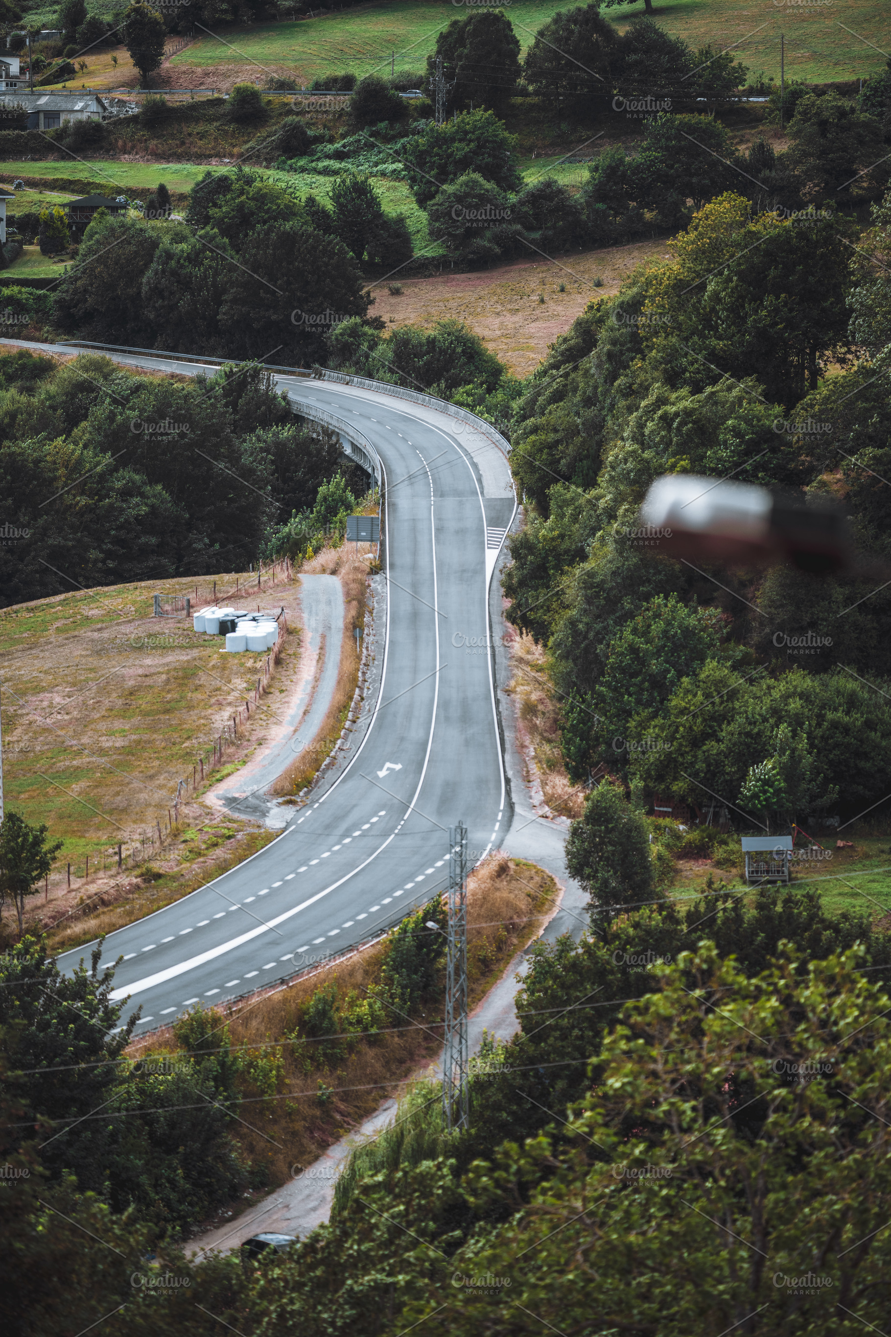 Curving Road Through Green Hills, a Transportation Photo by SkyNext