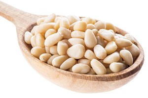 Pine nuts in the wooden spoon. White, a Photo by Volff